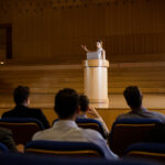 Female business executive giving a speech at conference center